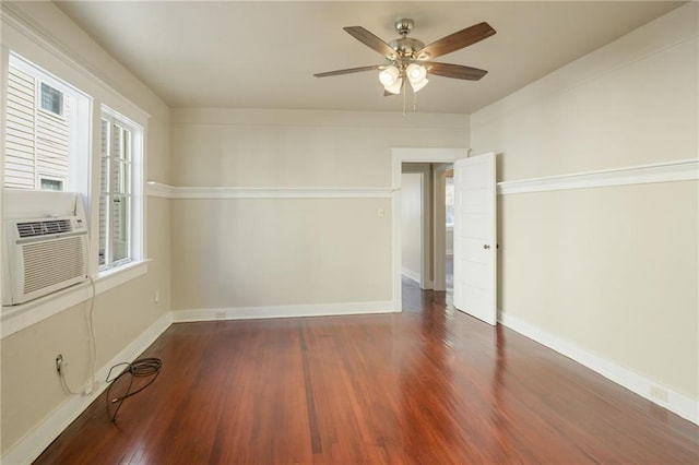 spare room featuring dark hardwood / wood-style floors, cooling unit, and ceiling fan