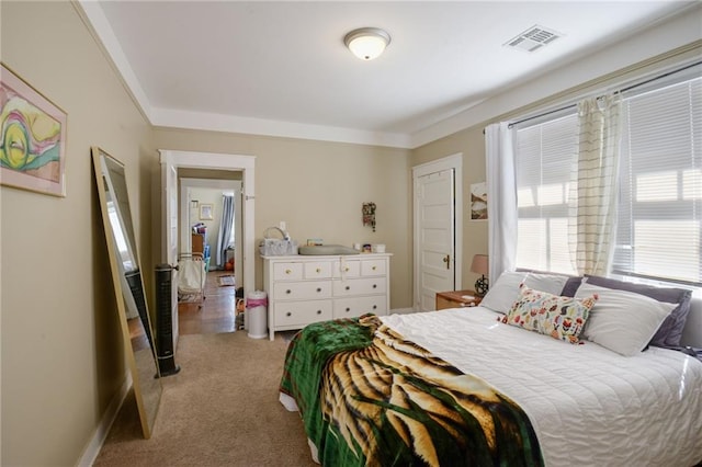 carpeted bedroom with ornamental molding