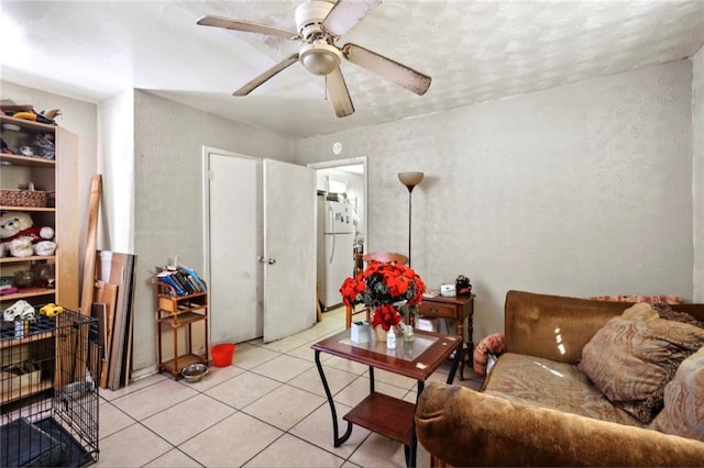 living room featuring ceiling fan and light tile patterned floors