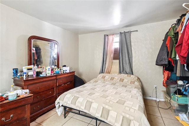 bedroom featuring light tile patterned floors