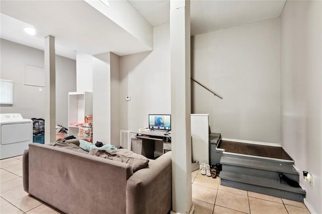 living room featuring washer / clothes dryer and light tile patterned flooring