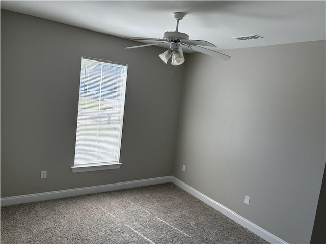 carpeted spare room featuring ceiling fan