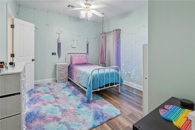 bedroom with hardwood / wood-style floors and ceiling fan