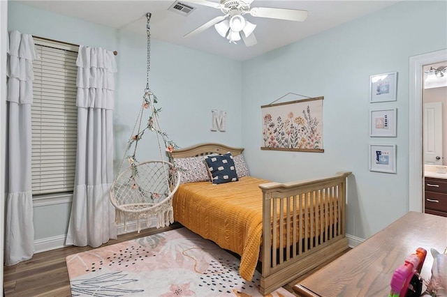 bedroom featuring ensuite bath, ceiling fan, and hardwood / wood-style floors