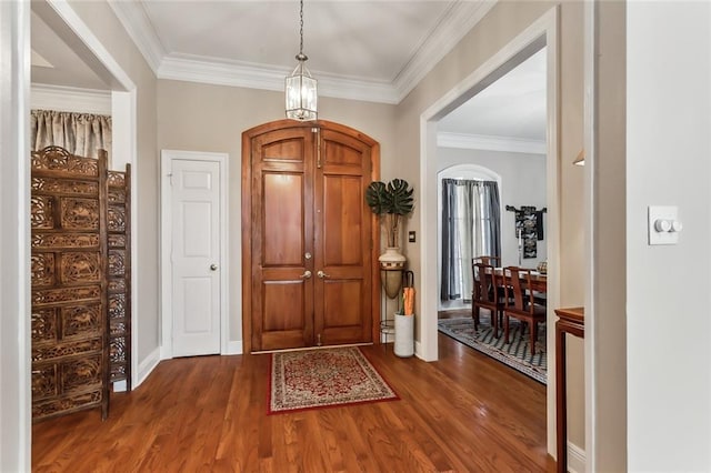 foyer entrance featuring ornamental molding and dark hardwood / wood-style floors