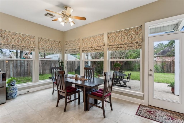 sunroom / solarium featuring ceiling fan