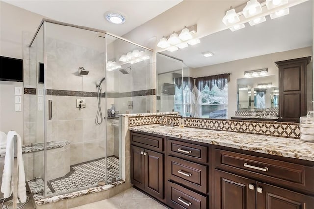 bathroom with tile patterned flooring, vanity, and an enclosed shower