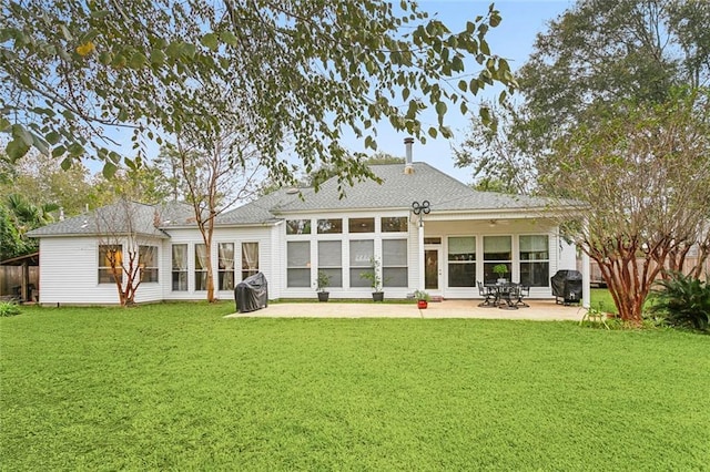 back of property featuring a yard and a patio