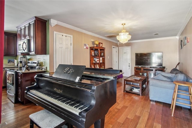 1311 Frenchmen St, New Orleans, LA 70116 - living room featuring a chandelier, wood-type flooring, and ornamental molding