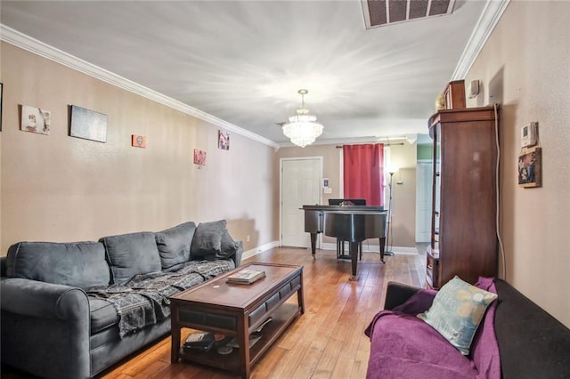 1311 Frenchmen St, New Orleans, LA 70116 - living area with crown molding, light wood-style flooring, a chandelier, and baseboards