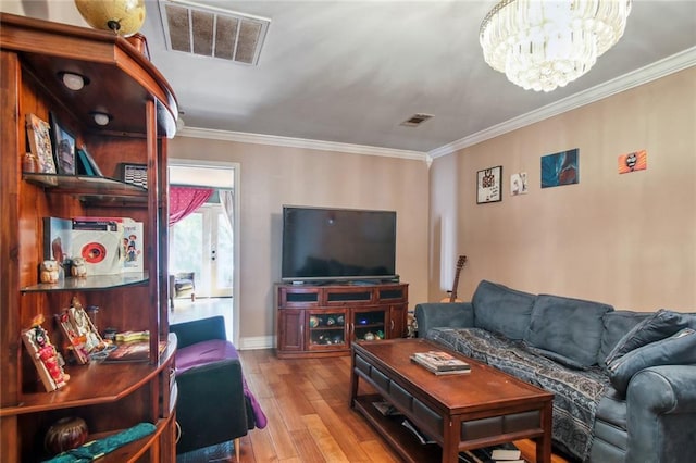 1311 Frenchmen St, New Orleans, LA 70116 - living area featuring a chandelier, wood-type flooring, ornamental molding, and baseboards