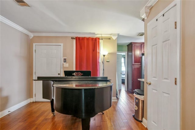 1311 Frenchmen St, New Orleans, LA 70116 - kitchen featuring wood-type flooring, crown molding, and baseboards