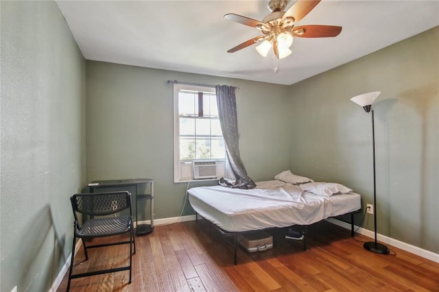 1311 Frenchmen St, New Orleans, LA 70116 - bedroom featuring wood-type flooring, cooling unit, baseboards, and ceiling fan