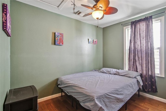 1311 Frenchmen St, New Orleans, LA 70116 - bedroom with multiple windows, baseboards, and wood finished floors