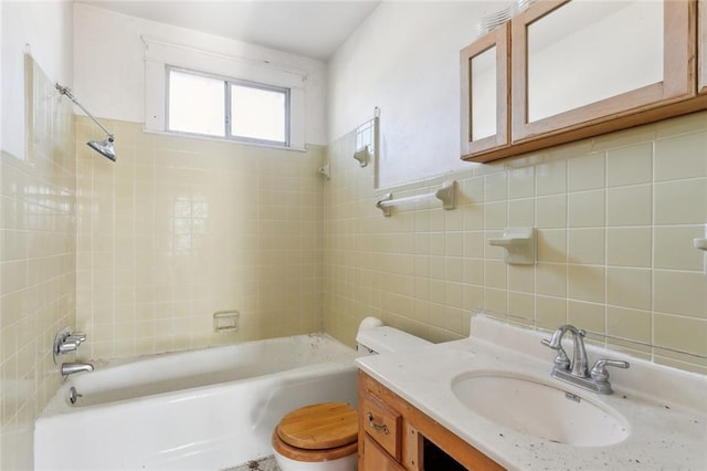 full bathroom with decorative backsplash, vanity, tiled shower / bath combo, tile walls, and toilet