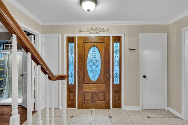 foyer entrance with light tile patterned floors and crown molding