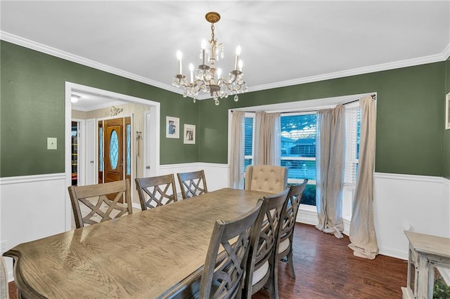 dining room with dark hardwood / wood-style flooring, an inviting chandelier, and crown molding