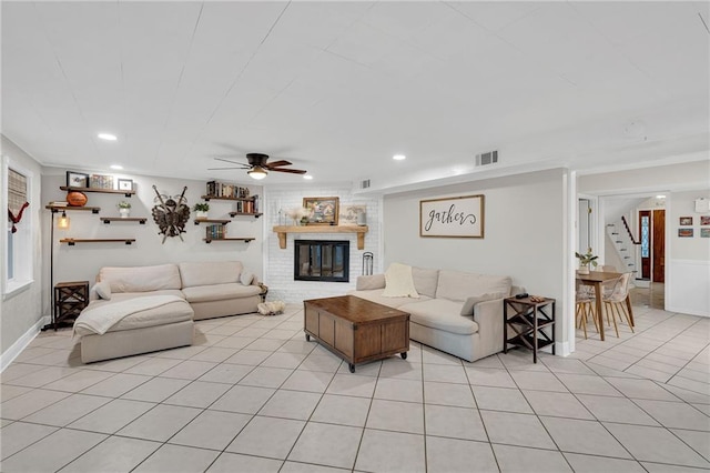 living room with ceiling fan, light tile patterned floors, and a fireplace