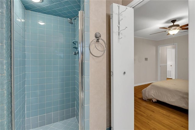 bathroom with hardwood / wood-style floors, a shower with door, ornamental molding, and ceiling fan