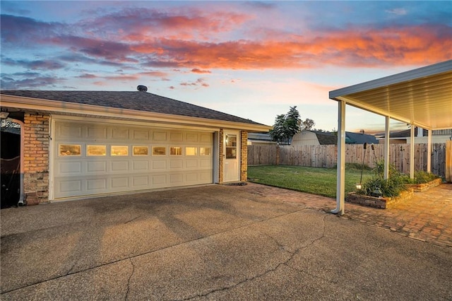 garage at dusk with a lawn