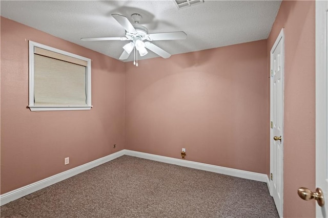 carpeted spare room featuring a textured ceiling and ceiling fan