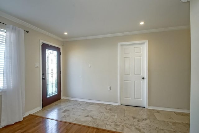 entryway featuring ornamental molding and light hardwood / wood-style flooring