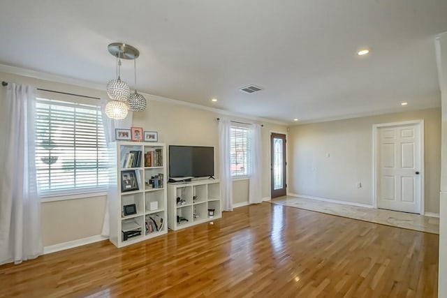 4520 Alphonse St, Metairie, LA 70006 - unfurnished living room featuring baseboards, ornamental molding, wood finished floors, recessed lighting, and a chandelier