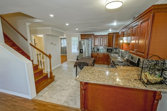 4520 Alphonse St, Metairie, LA 70006 - kitchen featuring stainless steel appliances, baseboards, crown molding, light stone counters, and backsplash