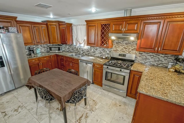 4520 Alphonse St, Metairie, LA 70006 - kitchen featuring appliances with stainless steel finishes, under cabinet range hood, a sink, ornamental molding, and decorative backsplash