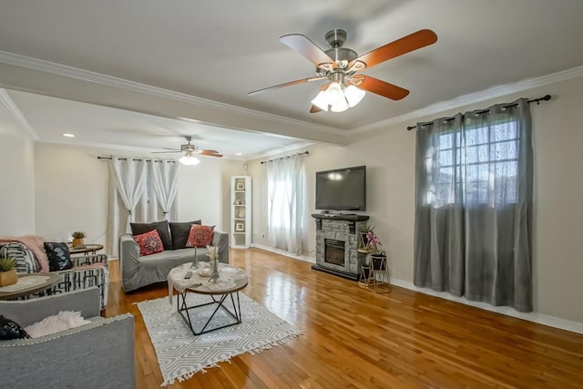 living room featuring a fireplace, wood-type flooring, and ornamental molding