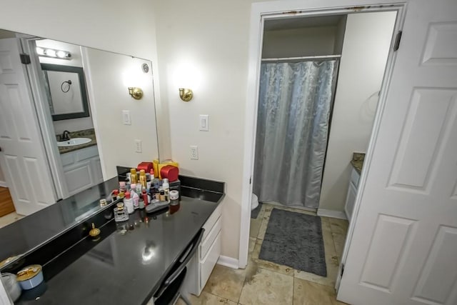 bathroom with curtained shower and vanity