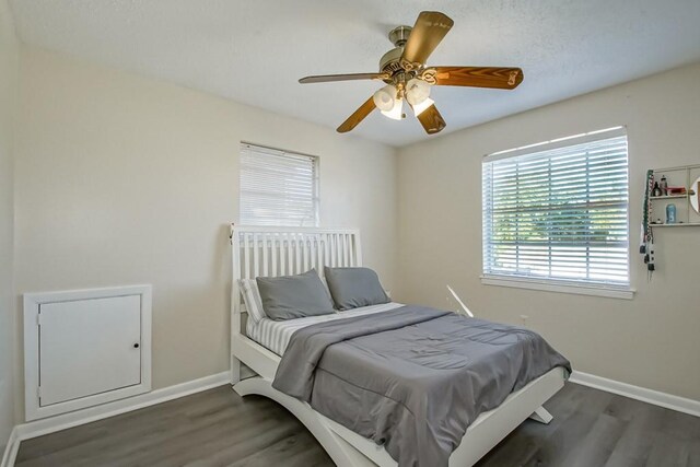 bedroom with ceiling fan and dark hardwood / wood-style flooring