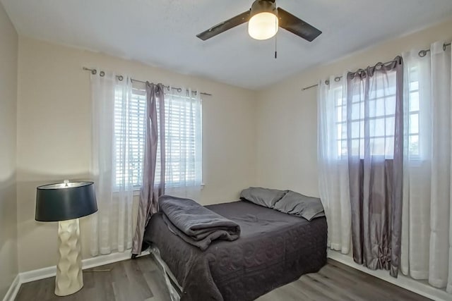 bedroom featuring ceiling fan and dark wood-type flooring