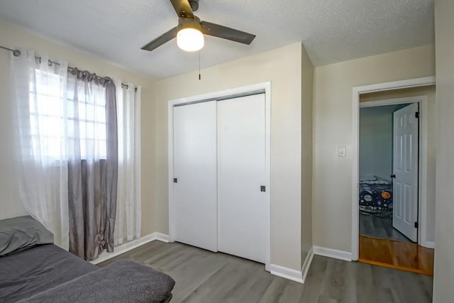 4520 Alphonse St, Metairie, LA 70006 - bedroom featuring wood finished floors, a closet, baseboards, a ceiling fan, and a textured ceiling
