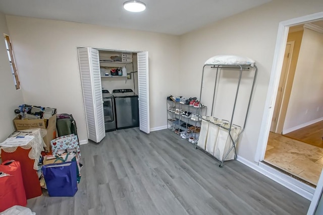 interior space featuring hardwood / wood-style flooring and washing machine and clothes dryer