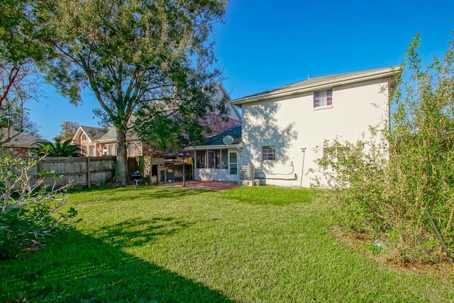 back of house with a patio area and a lawn