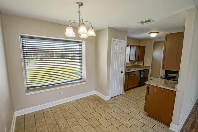 kitchen with light stone countertops, sink, black dishwasher, an inviting chandelier, and decorative light fixtures