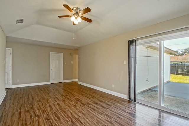 unfurnished room featuring ceiling fan, a raised ceiling, and wood-type flooring