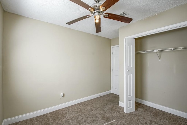 unfurnished bedroom with ceiling fan, a closet, carpet, and a textured ceiling