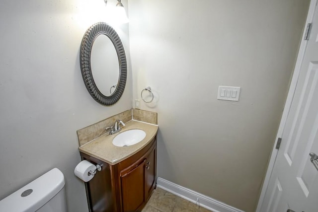 bathroom with tile patterned flooring, vanity, and toilet