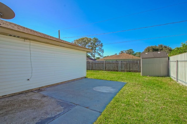 view of yard with a storage unit and a patio area