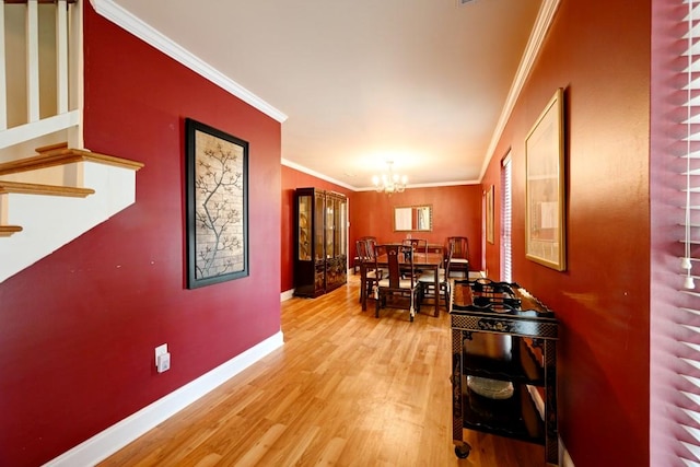 dining room featuring a chandelier, hardwood / wood-style floors, and ornamental molding