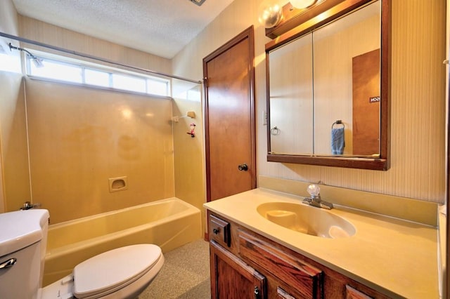 full bathroom with shower / washtub combination, vanity, a textured ceiling, and toilet