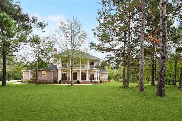 back of house with a porch and a lawn