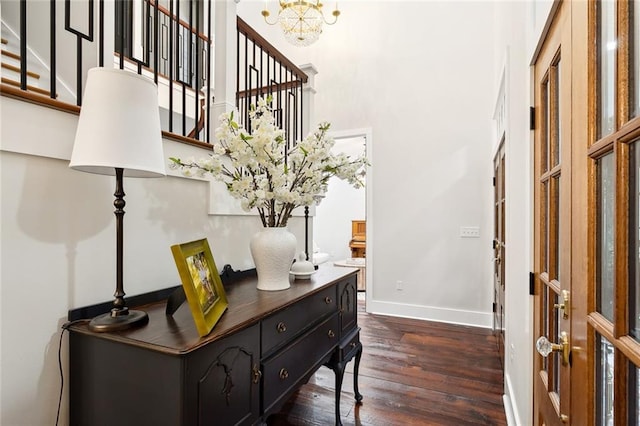 entrance foyer with a chandelier and dark hardwood / wood-style floors