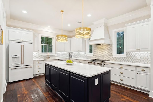 kitchen featuring dark hardwood / wood-style flooring, white cabinetry, and built in fridge