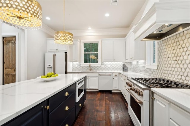 kitchen featuring pendant lighting, white appliances, dark wood-type flooring, white cabinets, and decorative backsplash