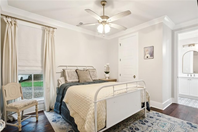 bedroom with ceiling fan, dark hardwood / wood-style flooring, ornamental molding, and ensuite bath