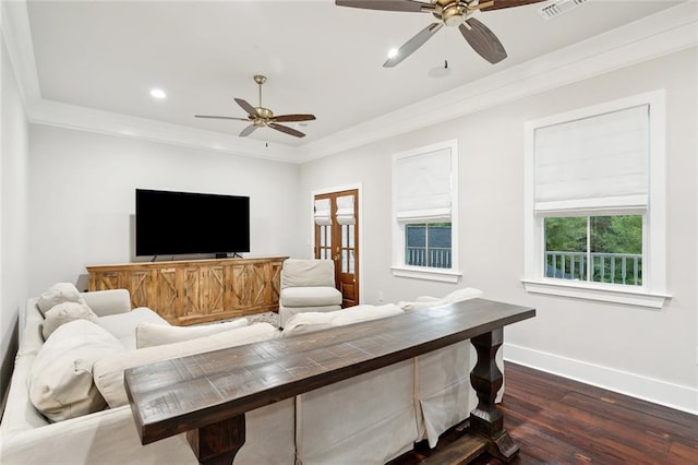 living room featuring dark hardwood / wood-style floors, ceiling fan, and crown molding