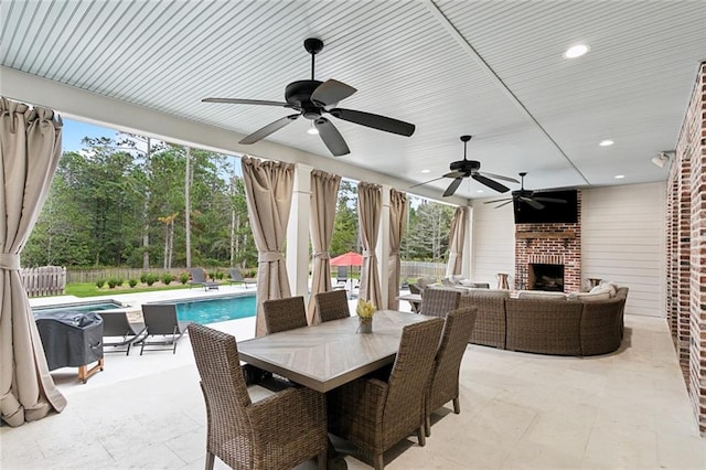 view of patio with a fenced in pool and an outdoor brick fireplace